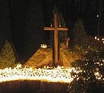 Hundreds_of_candles_and_a_Christian_Cross_at_a_cemetery_on_Christmas_eve